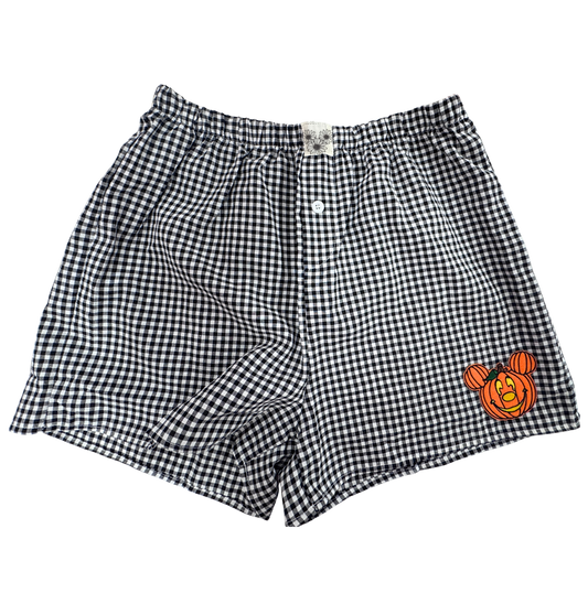 Black and white gingham check boxer shorts with a small orange Mickey Mouse graphic on the lower right leg, shown flat on a white background.